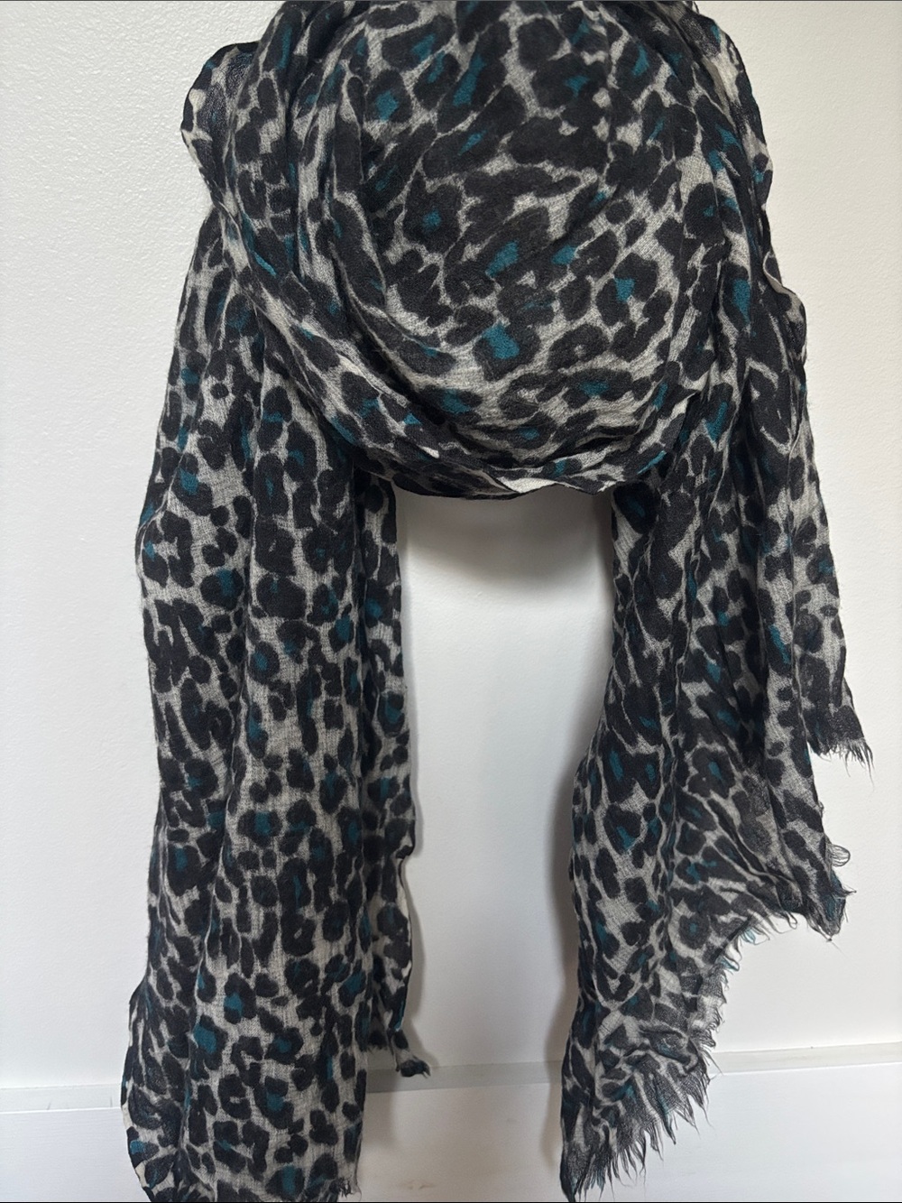 black and gray leopard-print scarf featuring subtle blue accents and eyelash